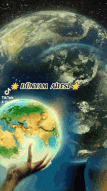 a person is holding a globe with the words dünyam ailesi on it