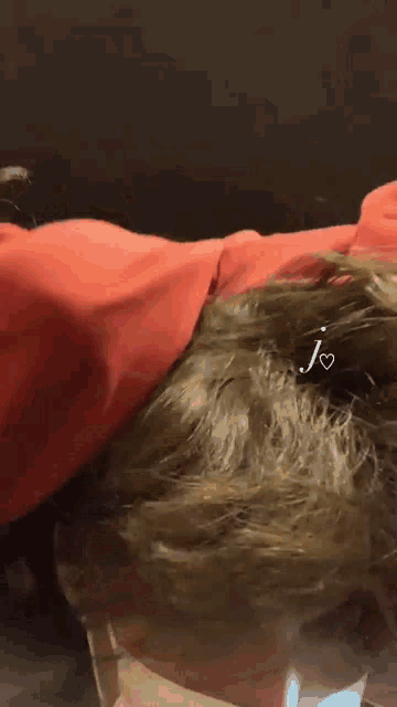 a close up of a person 's face with the letter j on it .