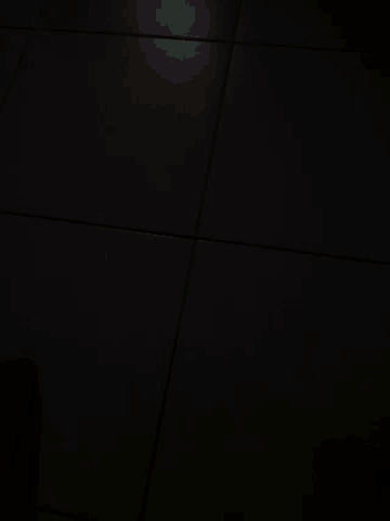 a person 's feet are on a white tile wall