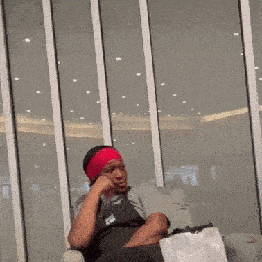 a woman wearing a red headband is sitting on a couch