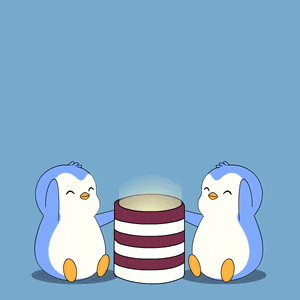 two penguins sitting next to a green candle with melted wax