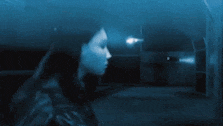 a dark room with a light coming through the window and smoke coming out of it