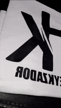 a white t-shirt with a black cross and the word rodasxy on it