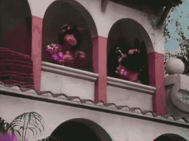 a couple of people standing on a balcony looking out at something