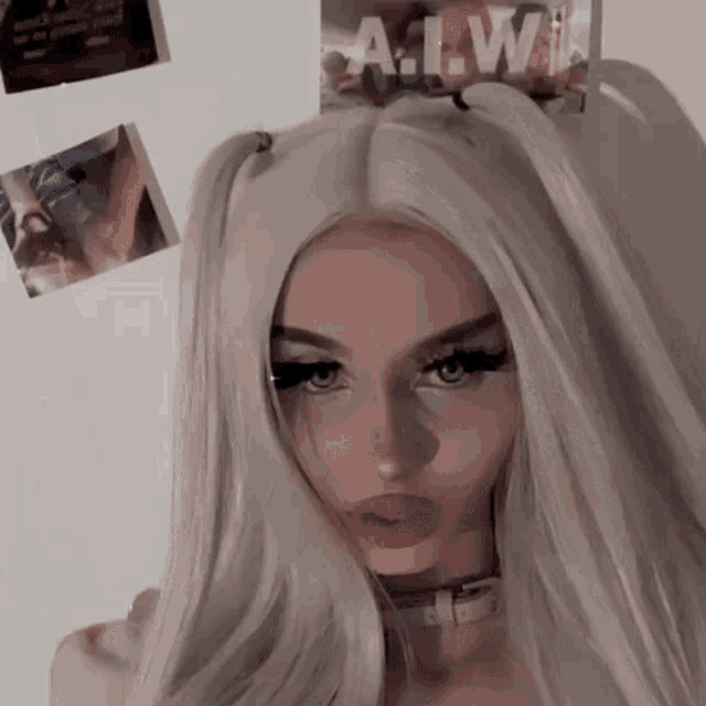 a girl with pigtails and a choker is standing in front of a wall with a poster that says a.w.