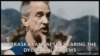 a man is making a funny face while talking about nebraska fans after hearing the dylan railoa news .