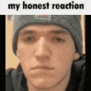 a close up of a man 's face with the words `` my honest reaction '' above it .