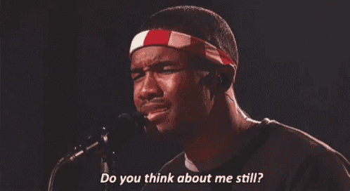 a man singing into a microphone with the words " do you think about me still " above him