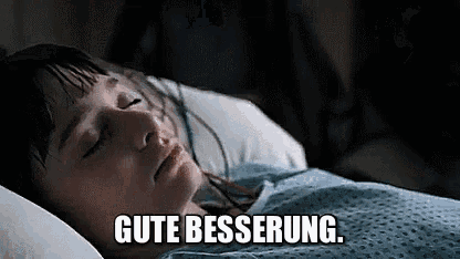a girl is laying in a hospital bed with her eyes closed and the words `` gute besserung '' .