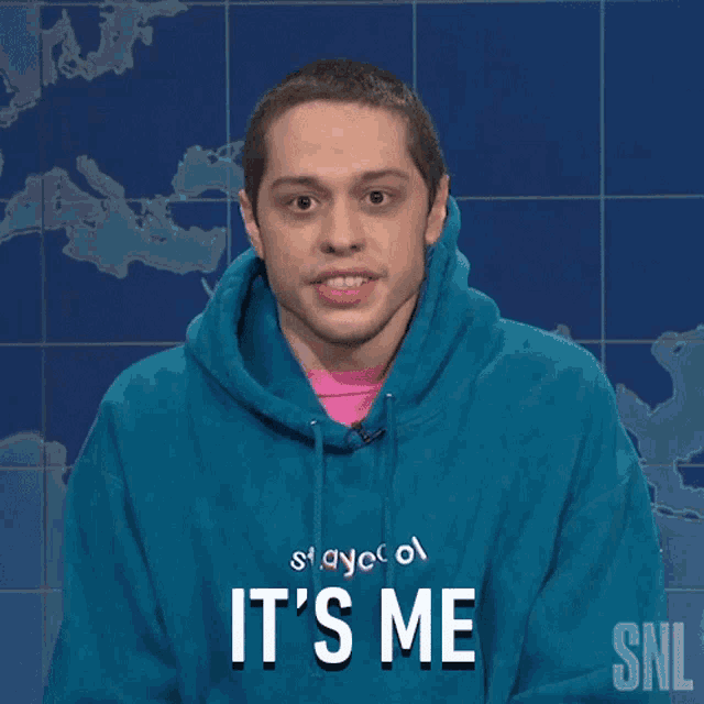a man wearing a blue hoodie that says " it 's me "