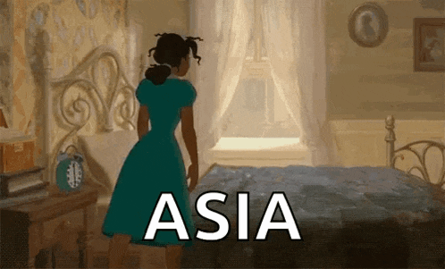 a woman in a blue dress is standing next to a bed with the word asia written on it
