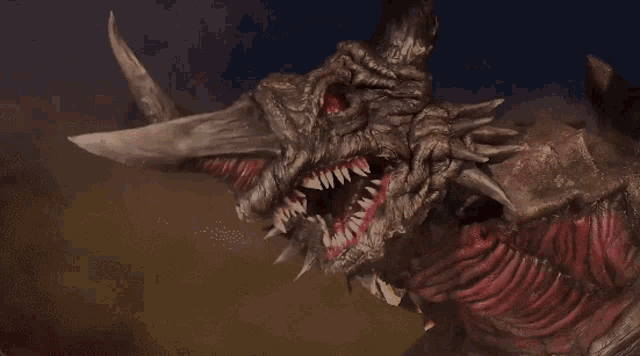 a monster with horns and sharp teeth is looking at the camera