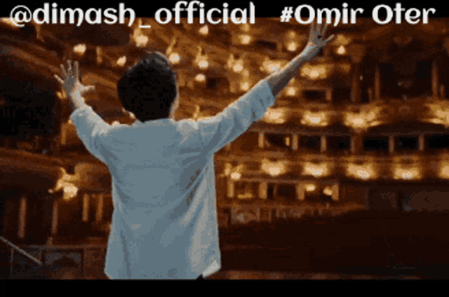 a man with his arms outstretched is standing in front of an empty auditorium with the hashtag omir oter on the top