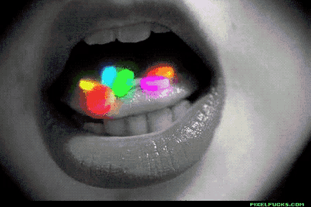 a black and white photo of a woman 's mouth with glow in the dark pills in it