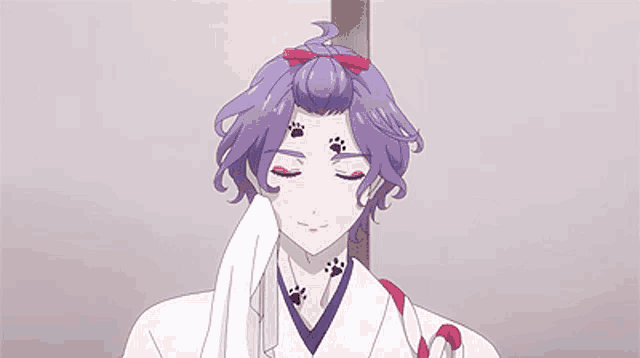 a man with purple hair and paw prints on his face is holding a white towel .
