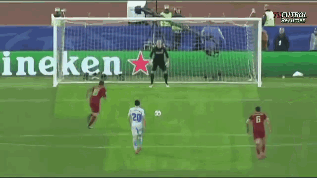 a soccer game is being played in front of a banner that says heineken