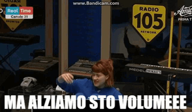 a woman sitting in front of a sign that says radio 105