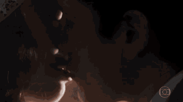 a close up of a man and woman kissing with a circle in the middle