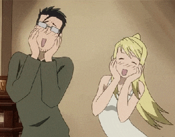 a man with glasses and a woman with blonde hair laughing