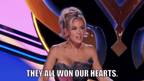 a woman says they all won our hearts while sitting on a stage