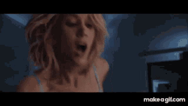 a woman with a surprised look on her face is standing in a room .