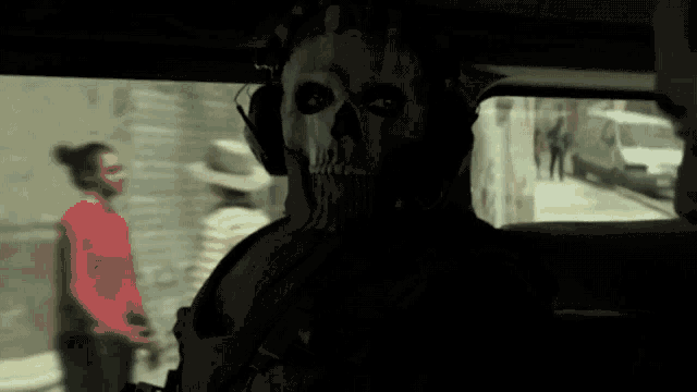 a man wearing a skull mask is sitting in a car .