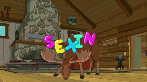 a moose standing in a cabin with the word sexin written on its head