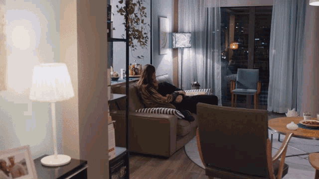 a woman sitting on a couch in a living room