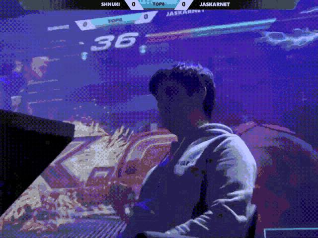 a man playing a video game with shinuki and jaskarnet in the background