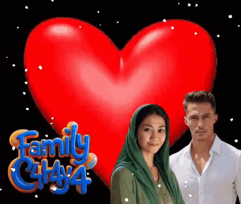 a man and a woman are standing in front of a large red heart that says family city 4 .