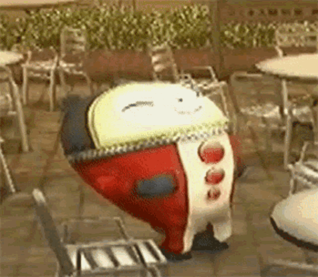 a cartoon character is standing on a chair in front of tables