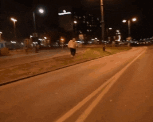 a blurry photo of a person walking down a street