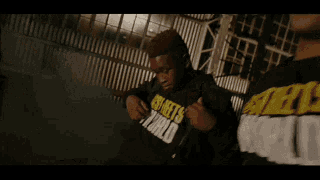 a man wearing a hoodie that says nfts on it