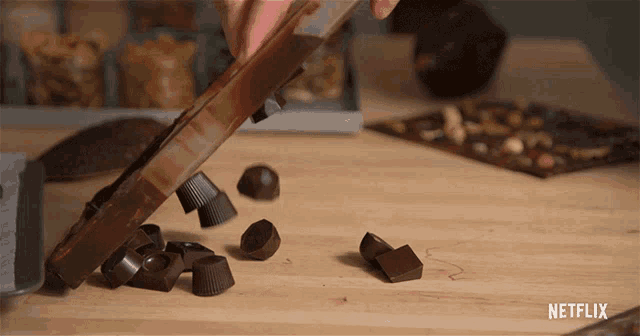 a netflix advertisement shows a person cutting chocolate