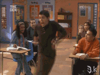 a group of people in a classroom with a sign that says the den on it