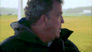 a close up of a man 's face in a field