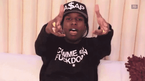 a man wearing a hat and a shirt that says comme des fuckdown .