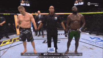 two men standing in a boxing ring with a bud light sign on the corner