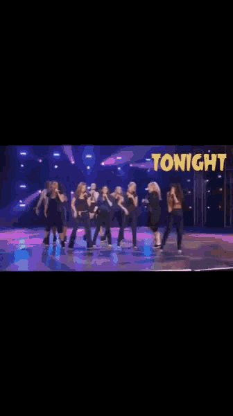 a group of women singing in front of a sign that says tonight on it