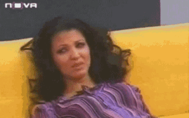 a woman sits on a yellow couch with nova written on the bottom