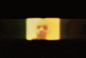 a blurry picture of a man 's face with a yellow and green background
