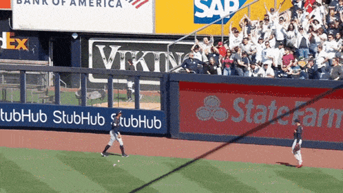 a baseball game is being played in front of a bank of america and sap advertisement