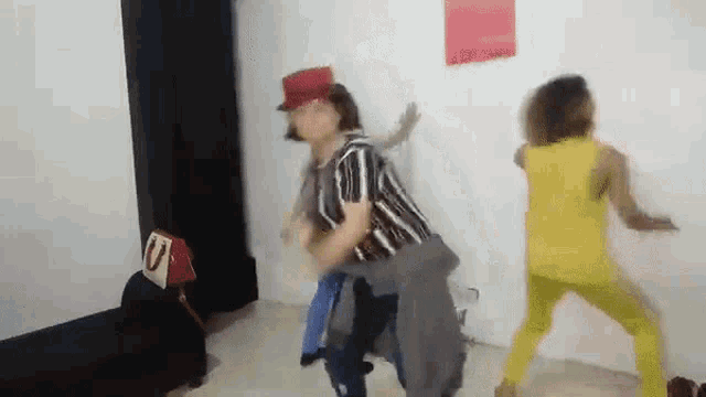 a group of people are dancing in a room with a red sign that says u on it .