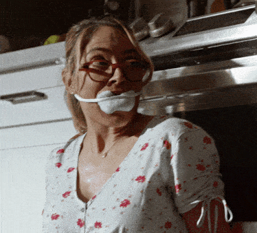 a woman with a bandage around her mouth and glasses