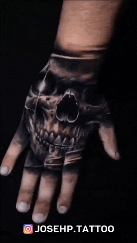 a hand with a skull tattoo on it