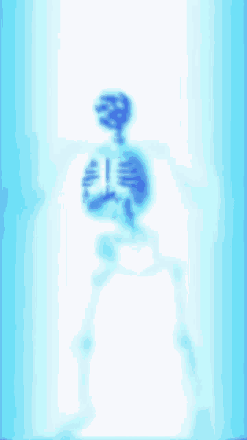 a blurry picture of a skeleton with a blue light behind it