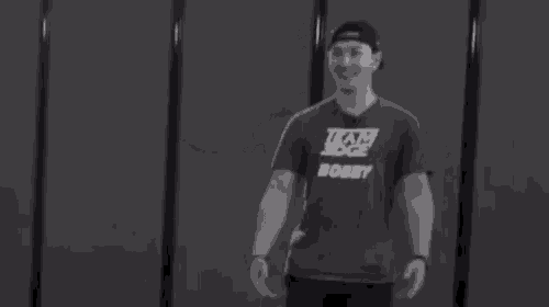 a black and white photo of a man wearing a t-shirt that says `` team edge '' .