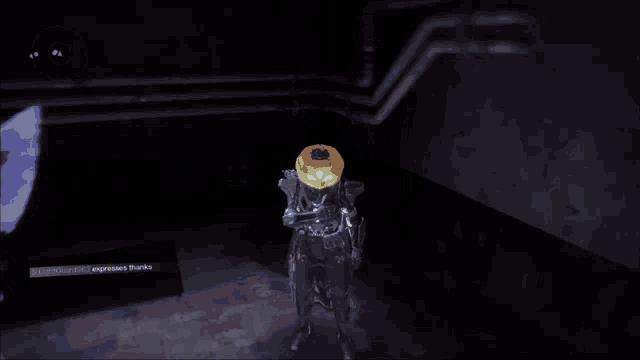 a robot with a pumpkin on its head is standing in a dark room