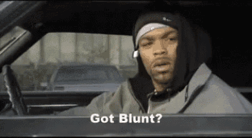 a man in a hoodie is sitting in a car with the words `` got blunt '' written on the screen .