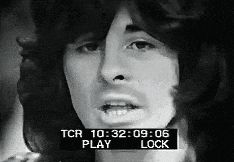 a black and white photo of a man 's face with a screen that says tcr play lock .